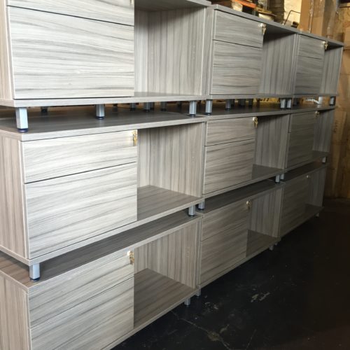 A lot of shelves with different sized drawers.