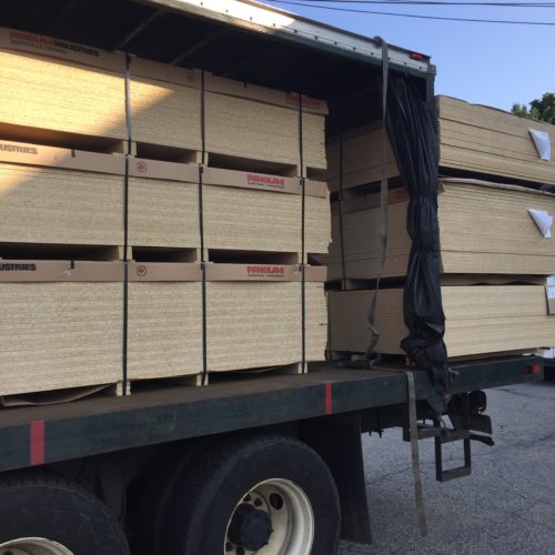 A trailer carrying a lot of wood