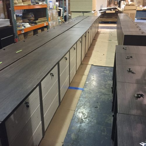 A long counter with many drawers and some cabinets