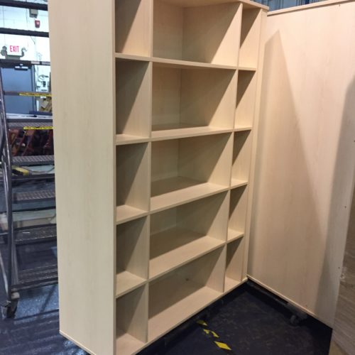 A white bookcase with many shelves in it